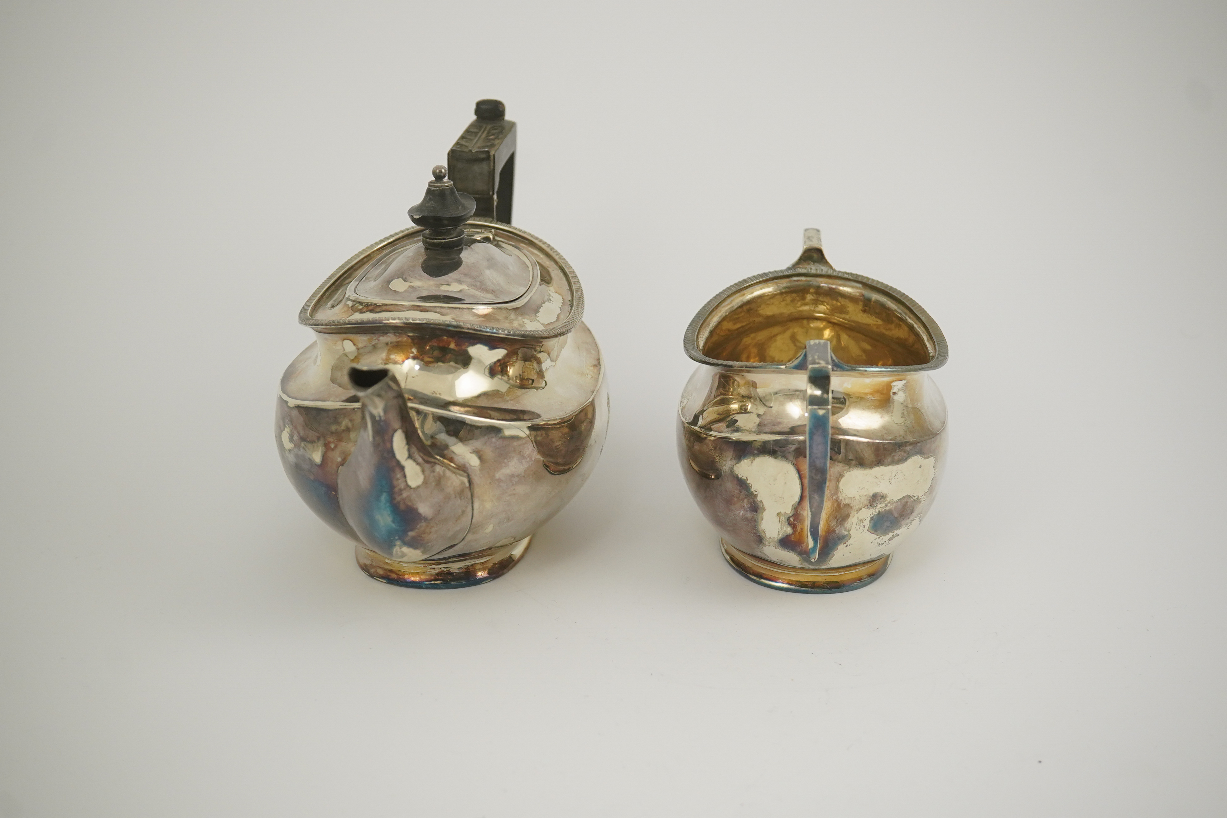 An Edwardian silver teapot and a matching sugar bowl, with engraved inscription, relating to the Royal Fusiliers, by Atkin Brothers